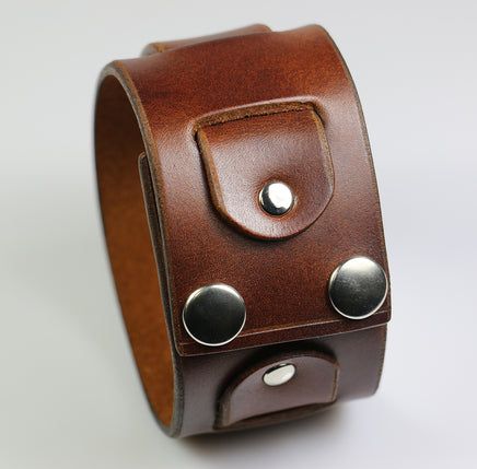 a brown leather bracelet with metal studs