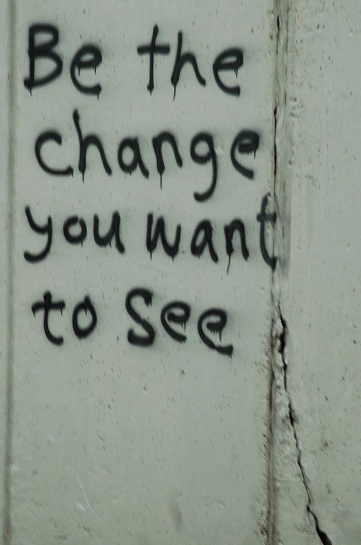 graffiti written on the side of a building saying be the change you want to see