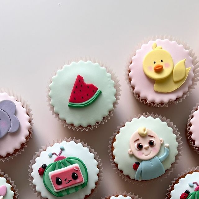 cupcakes with frosting and fondant designs on them