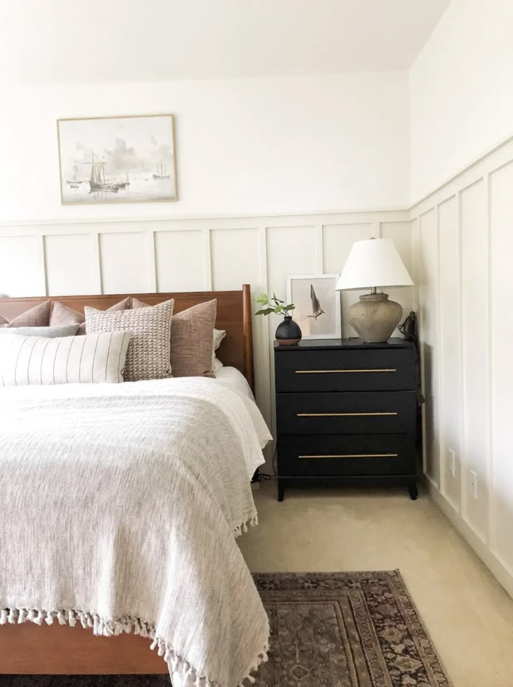 a bedroom with a bed, night stand and rug