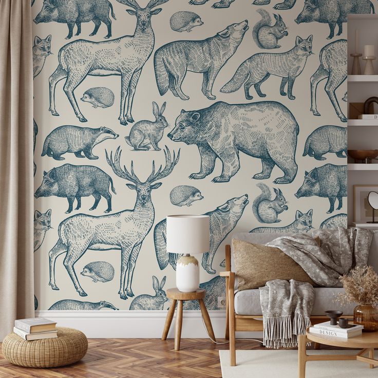 a living room with wallpaper that has various animals on it and is decorated in blue