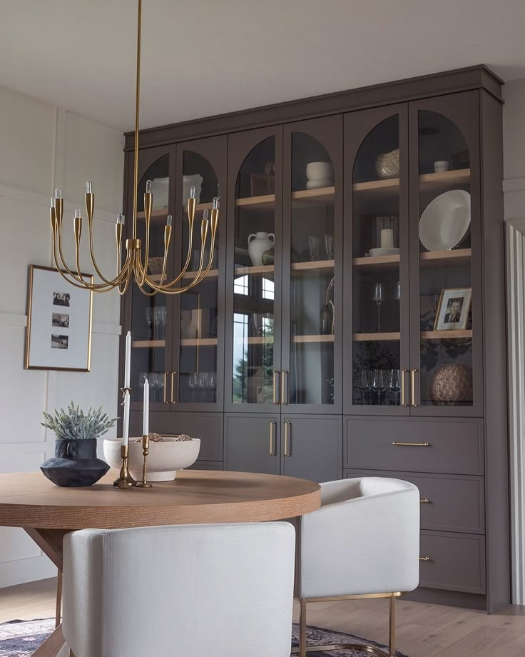 a dining room table with chairs and a chandelier