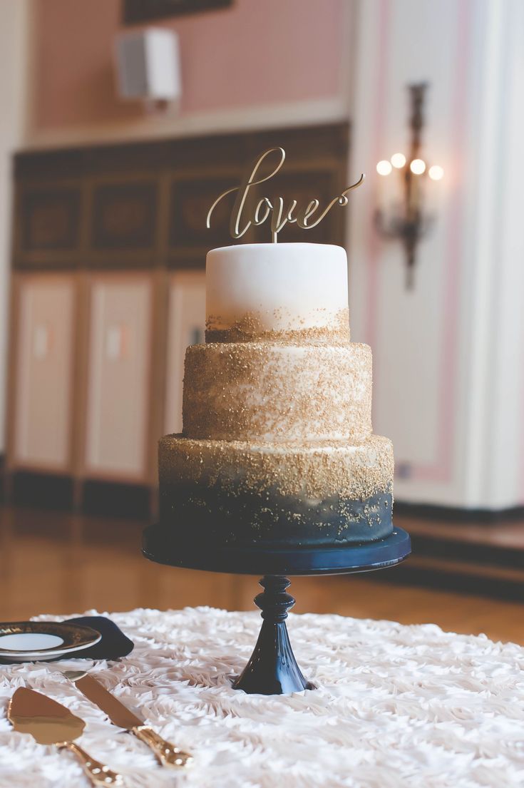 a wedding cake with the word love on top