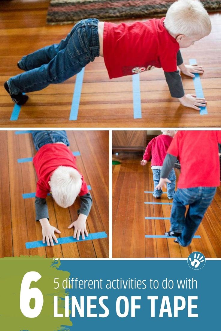 a boy is playing with tape on the floor