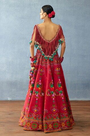 Red attached cancan lehenga with floral print and side pompom tassels. Paired with a fringed blouse with dangling cowrie shell details. - Aza Fashions Cape Lehenga, Lehenga And Blouse, Kurta Lehenga, Fringe Blouse, Lehenga Pattern, Lehenga Skirt, Casual Styles, Indian Textiles, Traditional Wear