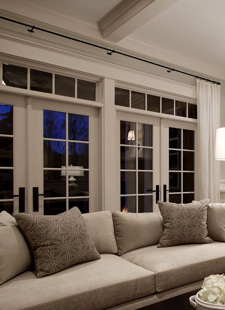 a living room filled with furniture and lots of windows