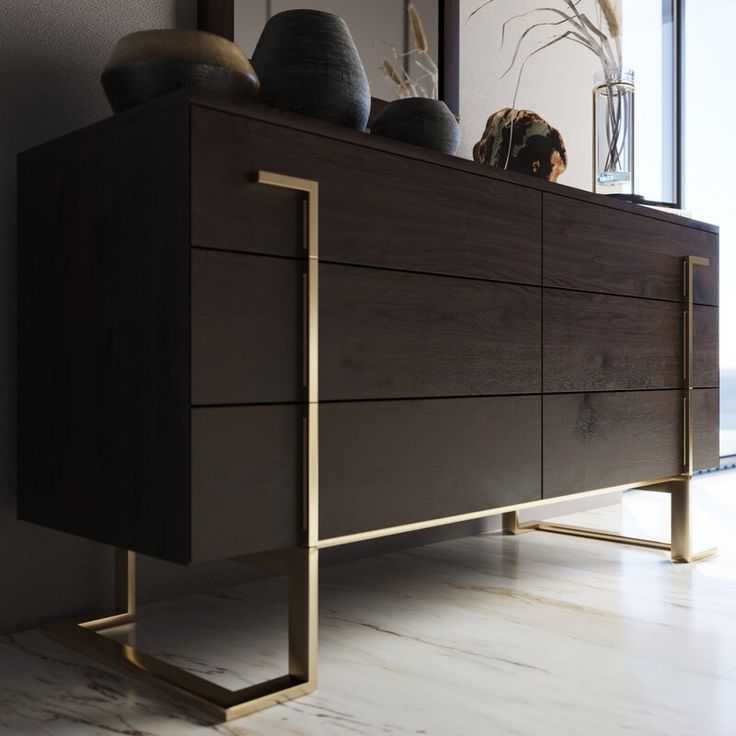 a modern dresser with two vases on top, and a large window in the background