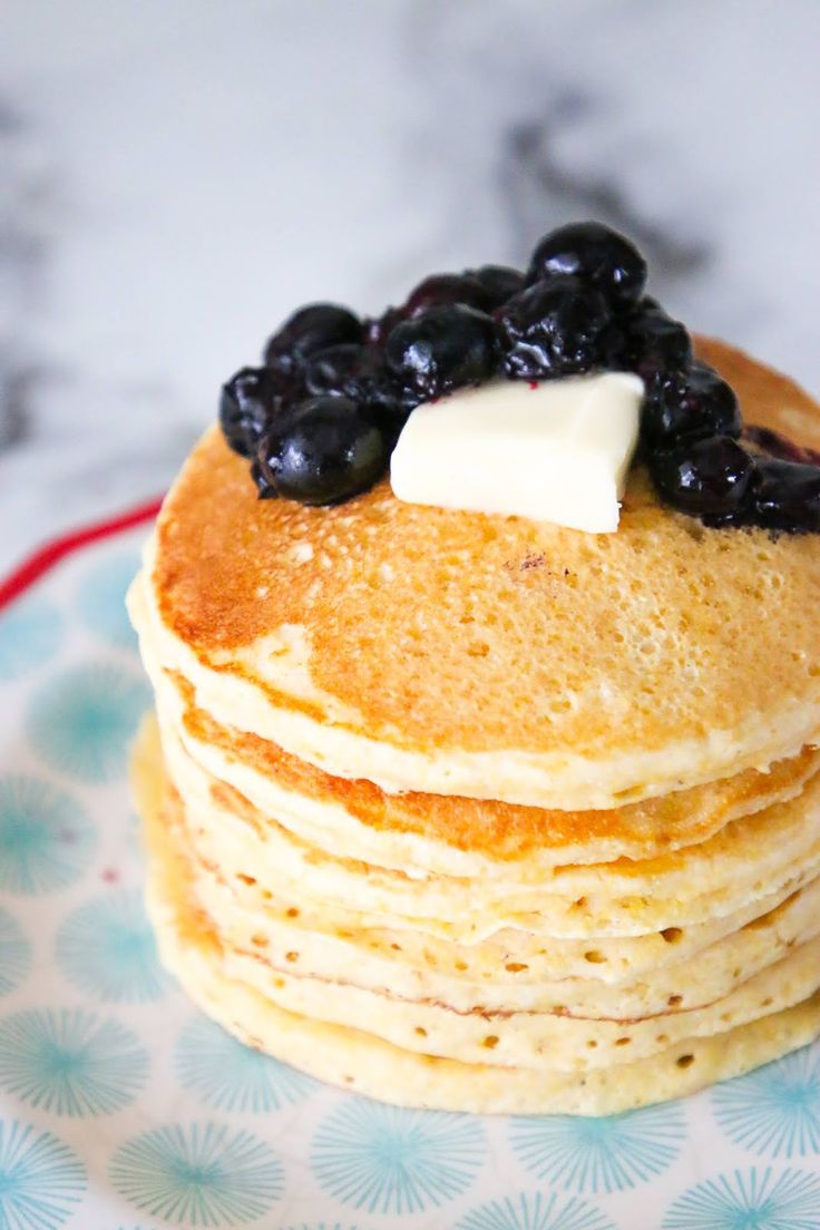 a stack of pancakes with blueberries and butter on top