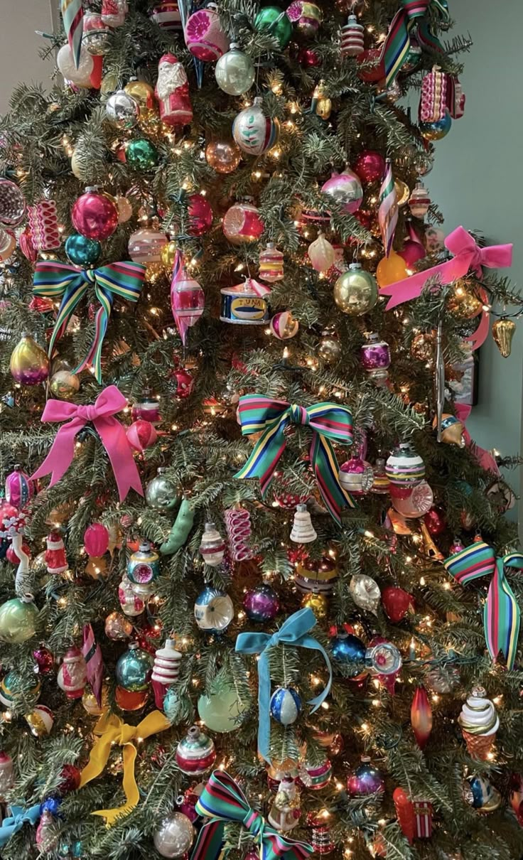 a christmas tree decorated with ornaments and bows