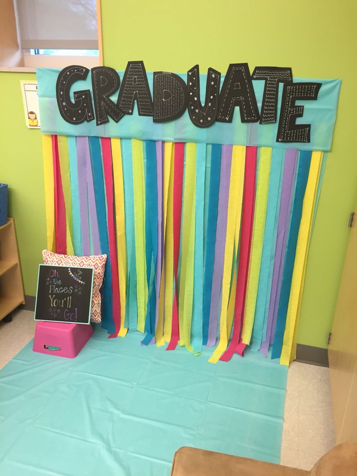 a classroom decorated with colorful streamers and a sign that says graduate on the wall