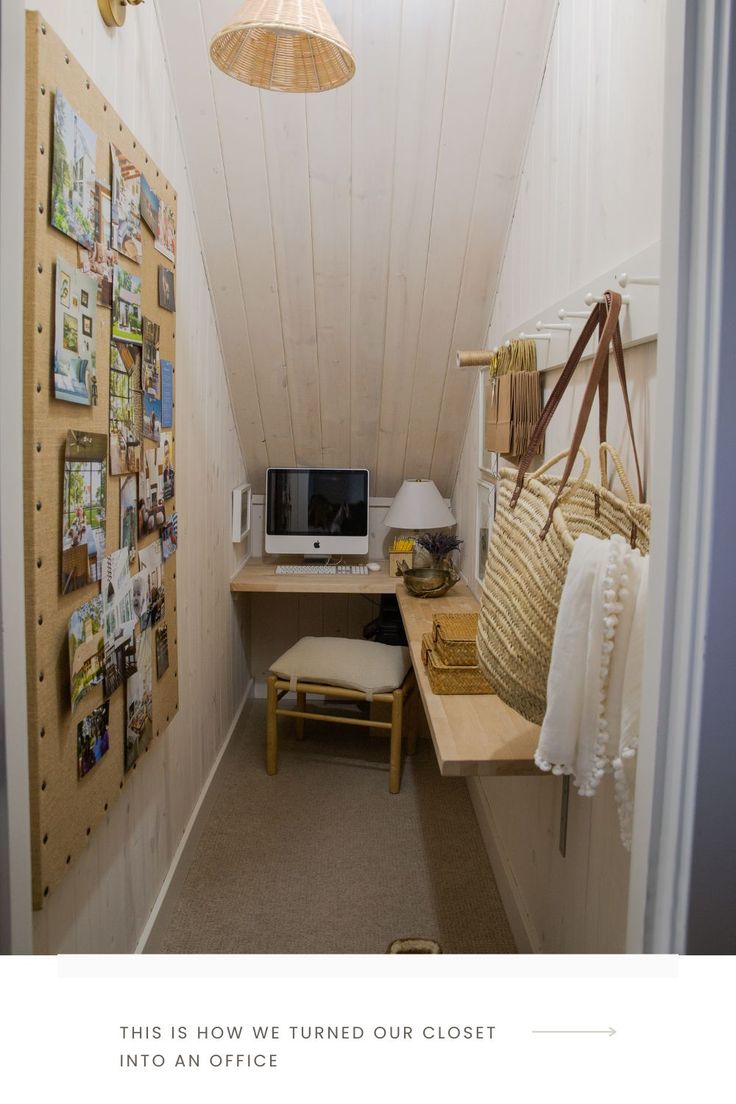 a small room with a desk, computer and pictures on the wall