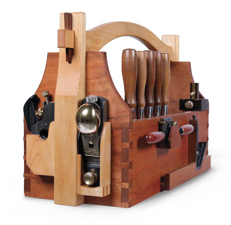 a wooden tool holder with many different tools in it's compartments, including knives and spoons