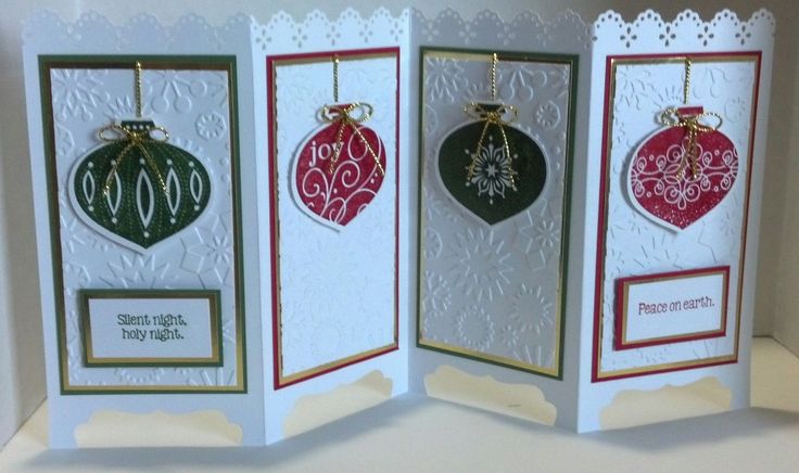 three christmas cards with ornaments hanging from them