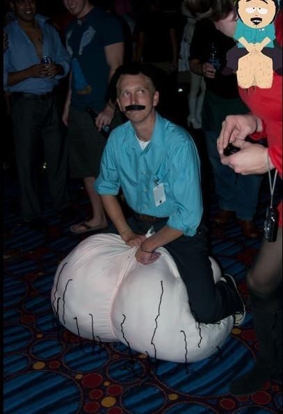 a man sitting on top of a bean bag chair in front of a group of people