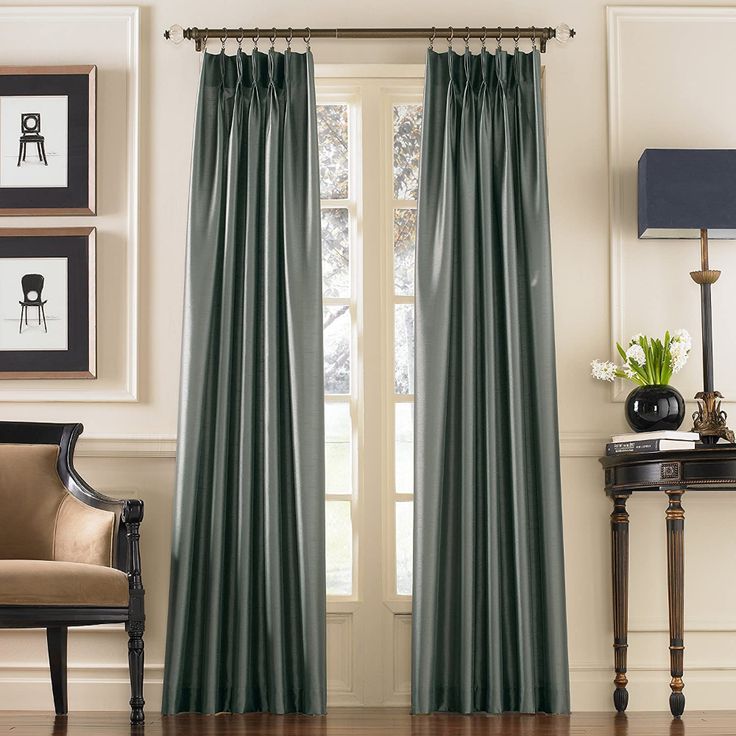 the dark gray curtains are hanging in front of a window