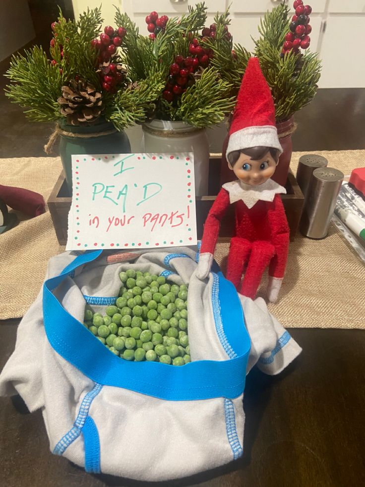 an elf is sitting next to a bag with peas in it