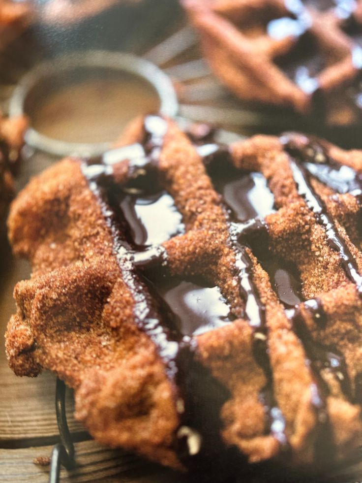 chocolate covered waffles sitting on top of a wooden table