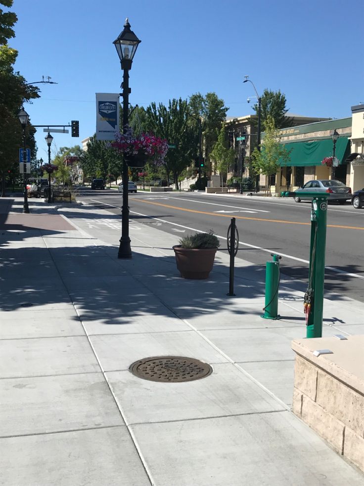 an empty sidewalk in the middle of a city with no people or cars on it