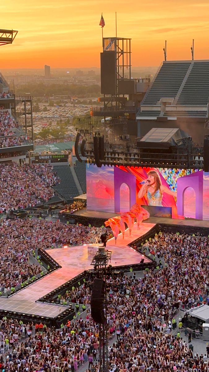 a large crowd is watching a concert on stage