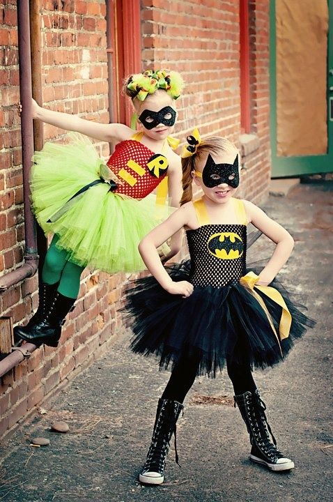 two children dressed up as batman and catwoman