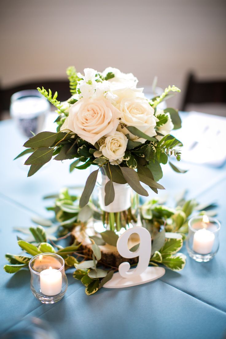 the table is set with flowers and candles