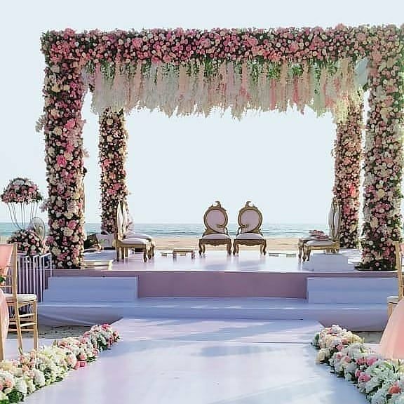 an outdoor ceremony set up with flowers and chairs