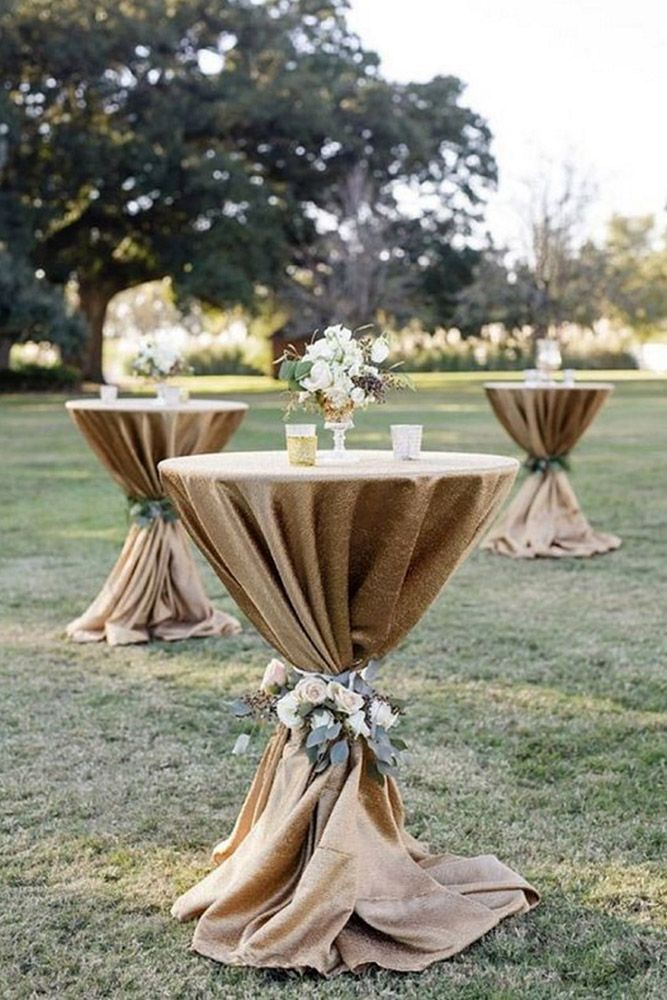 the tables are covered with burlocks and draping for an elegant look