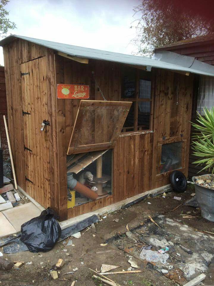 an outdoor chicken coop with the door open