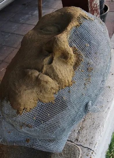 a large piece of rock sitting on top of a sidewalk