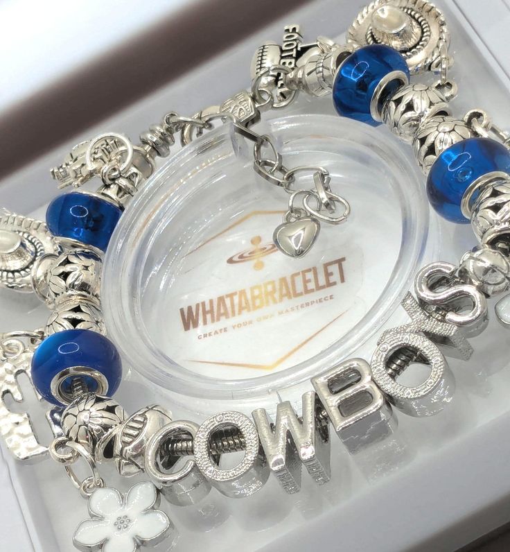 a bracelet with blue beads and charms on it that says, whataballet