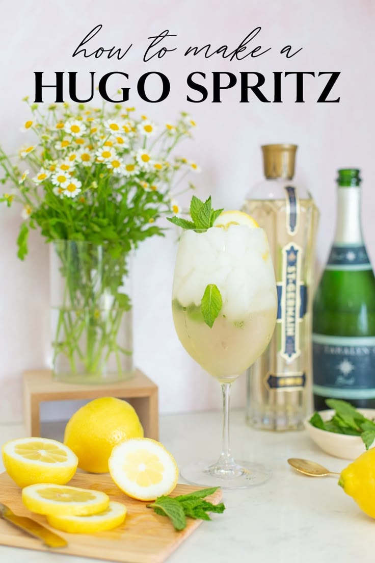 a glass filled with ice and lemons on top of a table next to bottles