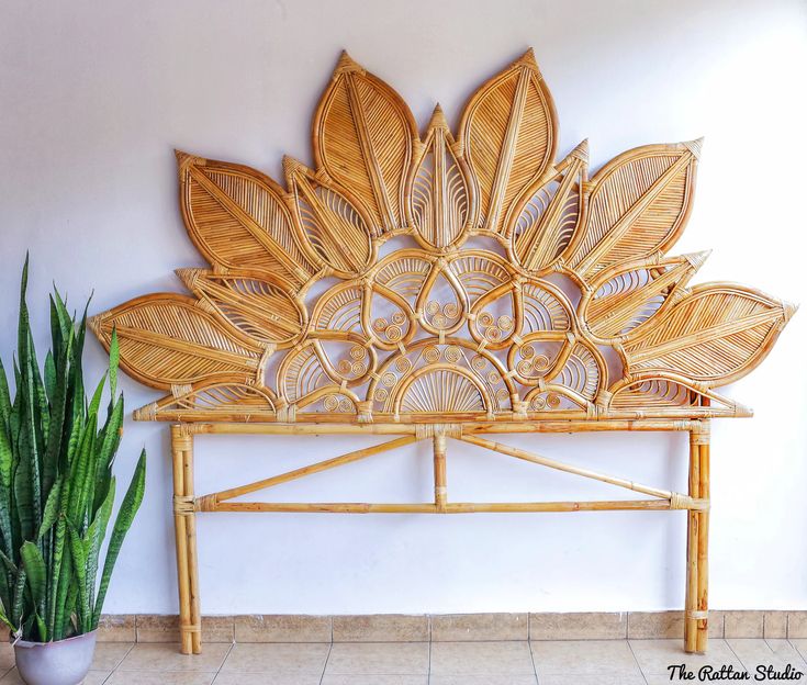 a wooden bench sitting next to a potted plant