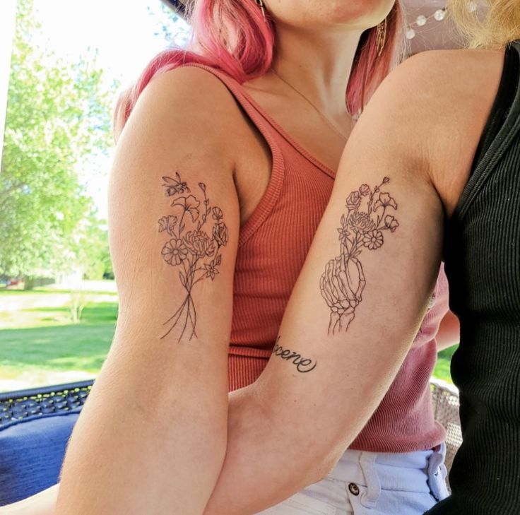 two women with matching tattoos on their arms