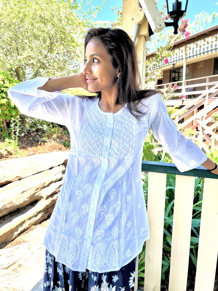 Theigh length tunic /Kurta with full front button opening is one of the gorgeous attire for warm weather. Airy and lightweight companion for a hot summer day. This beautiful Hand embroidered tunic/top is ideal for any functions/parties. If you want a classic look then pair it with leggings, skinny jeans, capri. This is a contemporary reflection of traditional Indian Chikan embroidered ethics which had originated centuries ago in Lucknow. Chikansazi being the exquisite needlework of fine and deli Relaxed Fit Blouse With Chikankari Embroidery For Summer, Spring Beach Top With Chikankari Embroidery, Summer Tops With Chikankari Embroidery, Traditional Long Sleeve Relaxed Fit Tunic, Peasant Style Embroidered Summer Tunic Top, Spring Tunic Kurta With Chikankari Embroidery, Vacation Long Sleeve Top With Chikankari Embroidery, Spring Chikankari Embroidery Top For Beach, Spring Chikankari Embroidery Tops