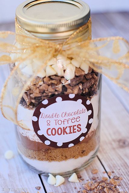 a jar filled with cookies on top of a wooden table