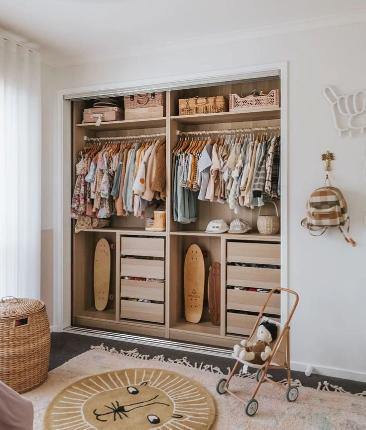 a baby's room with an organized closet and toy stroller in the foreground