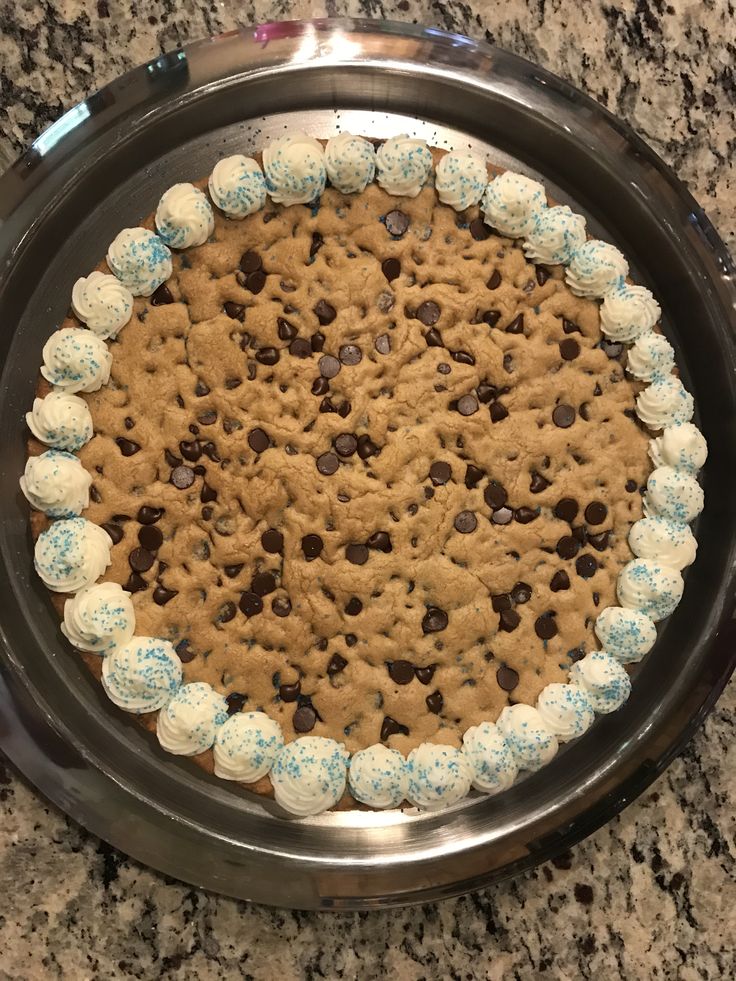 a cookie cake with chocolate chips and marshmallows on it in a pan