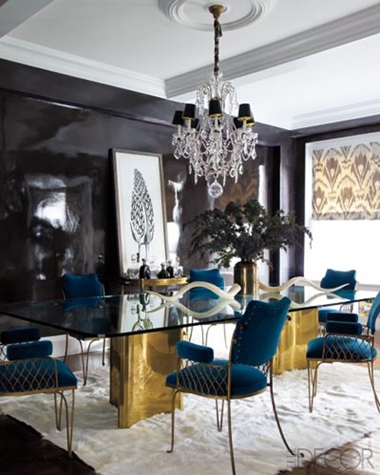 a dining room table with blue chairs and a chandelier