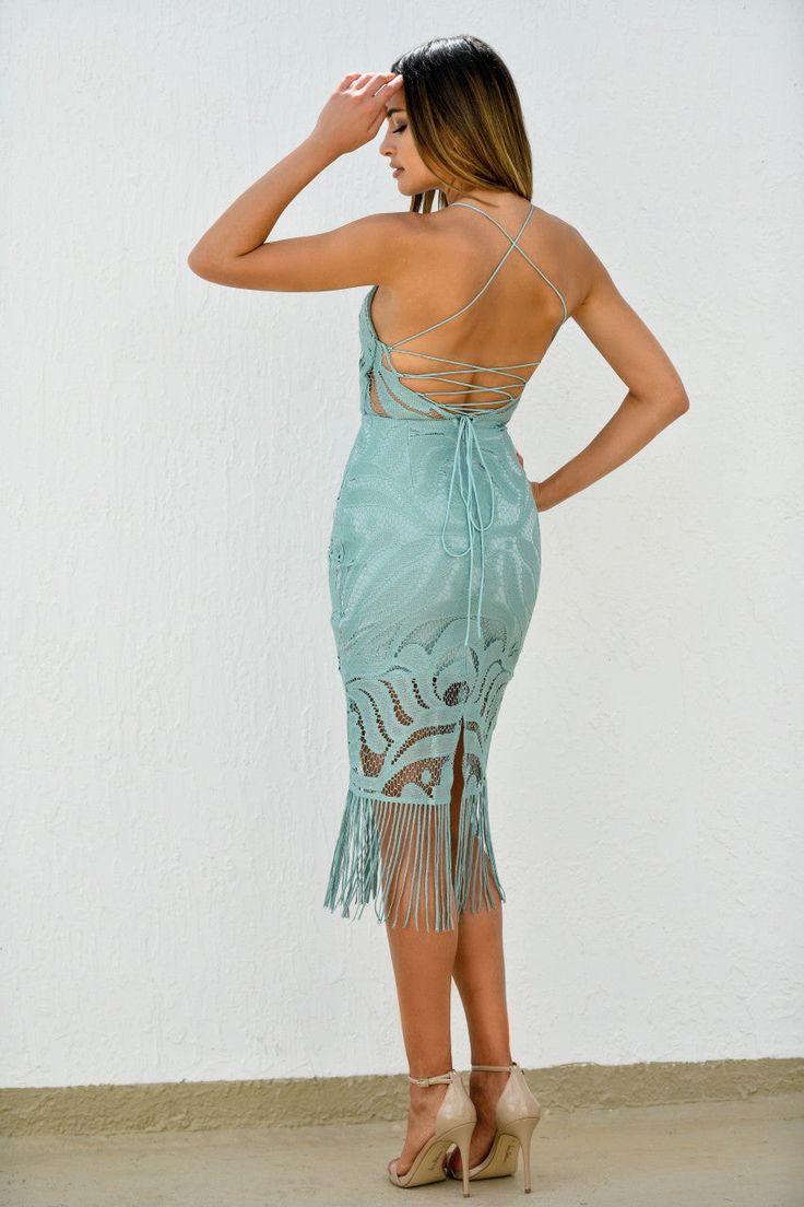 A woman stands with her back to the viewer, wearing a teal dress with intricate lace and fringes. She gazes to the side against a textured white wall and beige floor. Wedding Guest Black Tie, Khaleesi Dress, Sisters The Label, Bachelorette Party Dress, Champagne Dress, Rehearsal Dinner Dresses, Rehearsal Dress, Maxi Dress Wedding, Floor Length Gown