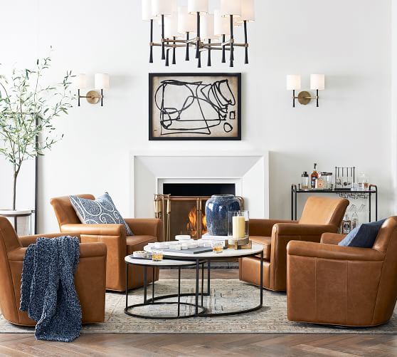 a living room filled with furniture and a fire place in the middle of the room