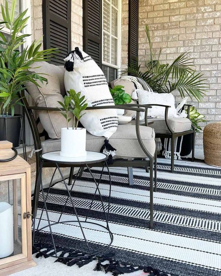 a porch with plants and chairs on it