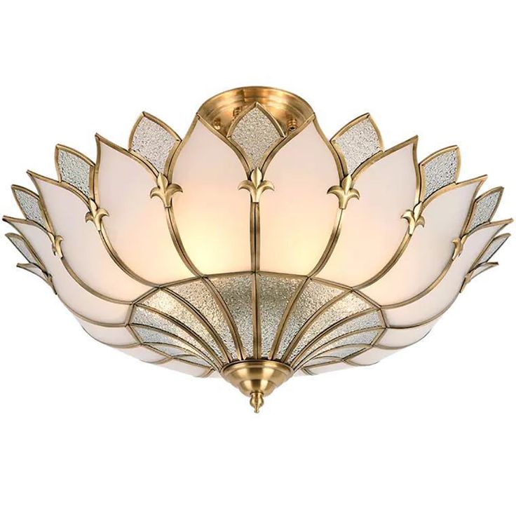 a light fixture with a flower design on the bottom and white glass in the middle