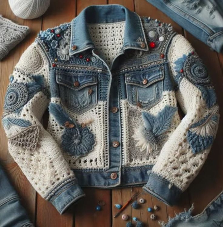 a denim jacket with crocheted details and buttons on the back, sitting on a wooden floor