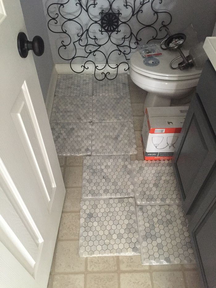 a bathroom with a toilet and tiled floor