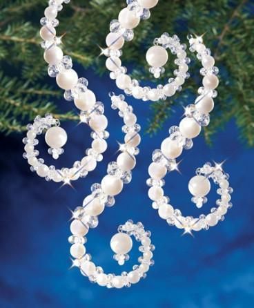 an ornament hanging from a christmas tree with pearls and crystal beads on it