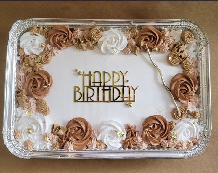 a birthday cake decorated with flowers and the words happy birthday written in gold on it