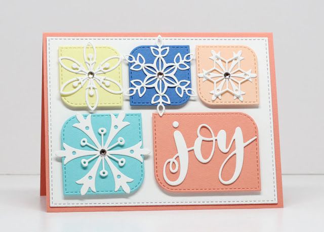 a card with snowflakes on it and the word joy written in different colors