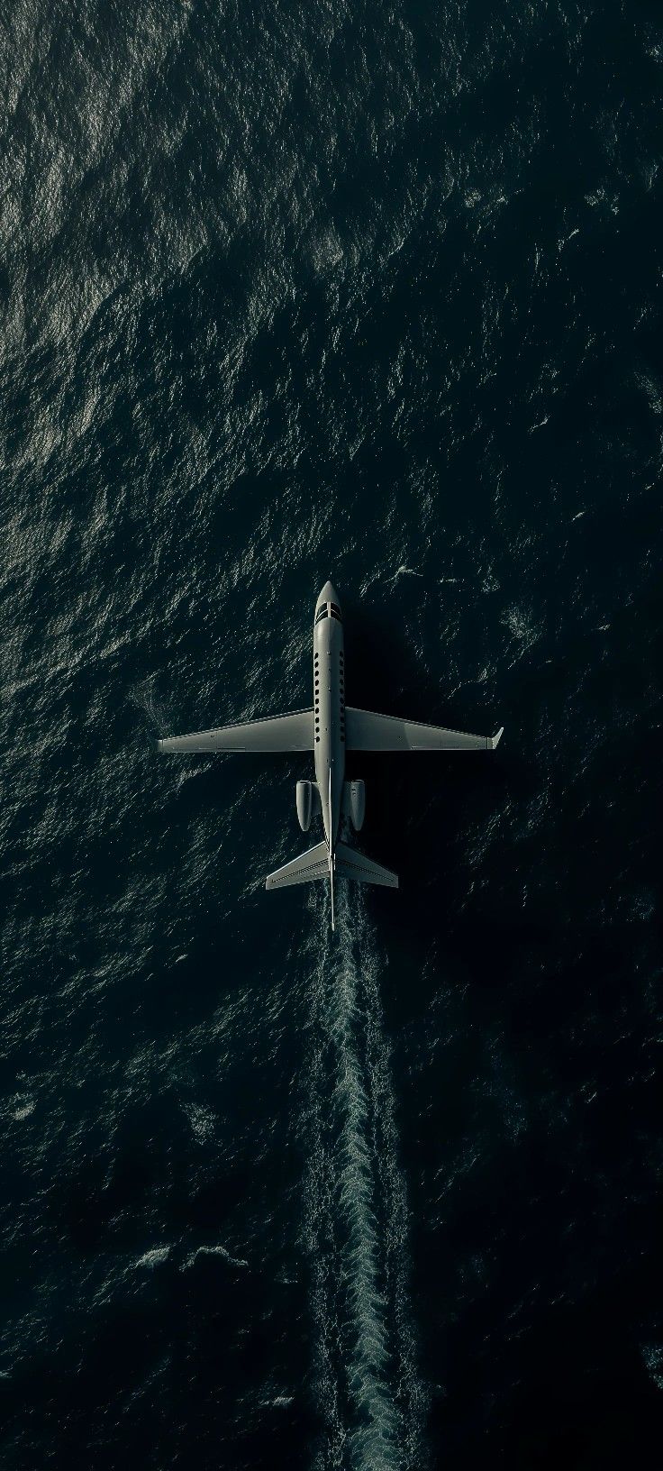 an airplane is flying low over the ocean water in this aerial photo taken from above