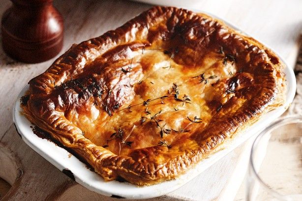 a large pot pie sitting on top of a white plate