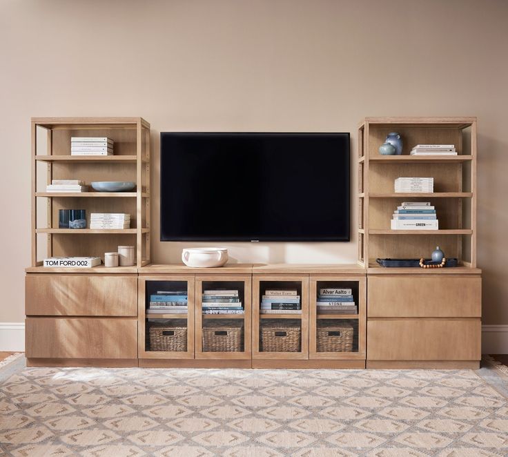 an entertainment center with bookshelves and a flat screen tv